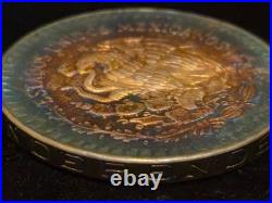 1984 Mexico Libertad 1 Onza. 999 fine silver BU coin with Fire Bleu Gold Toning